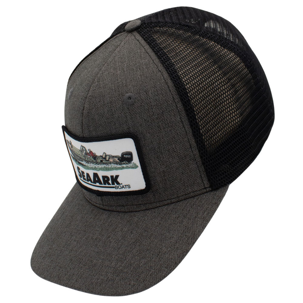 Side of a dark gray heather trucker hat with black mesh back panels and a white rectangular patch on the front.