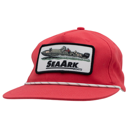 A red baseball cap with a white embroidered patch on the front that reads 'SEAARK BOATS' and shows a boat illustration. A white rope runs across the brim.