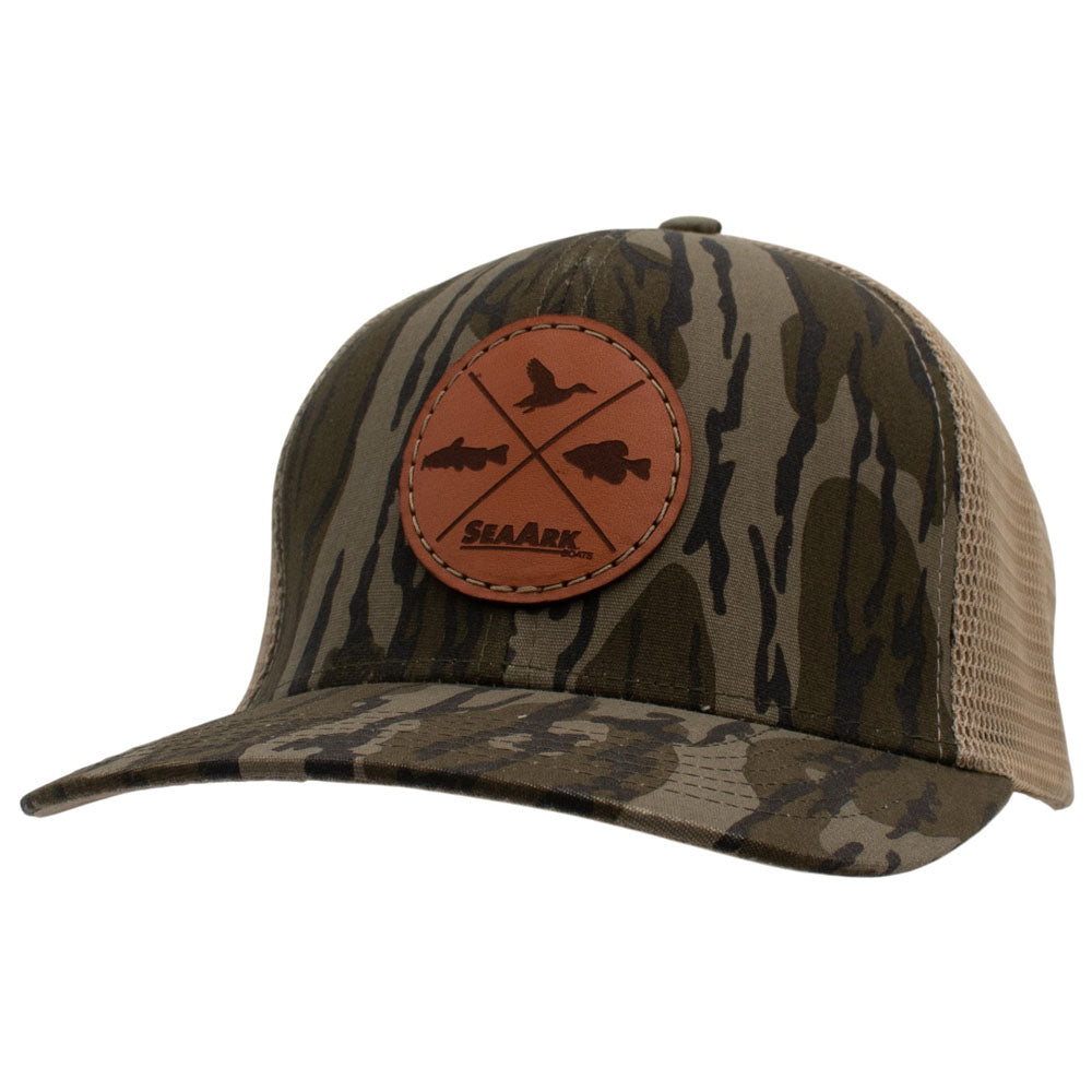 A camouflage trucker hat with a brown leather patch on the front featuring a duck silhouette and the brand name 'SEAARK'.