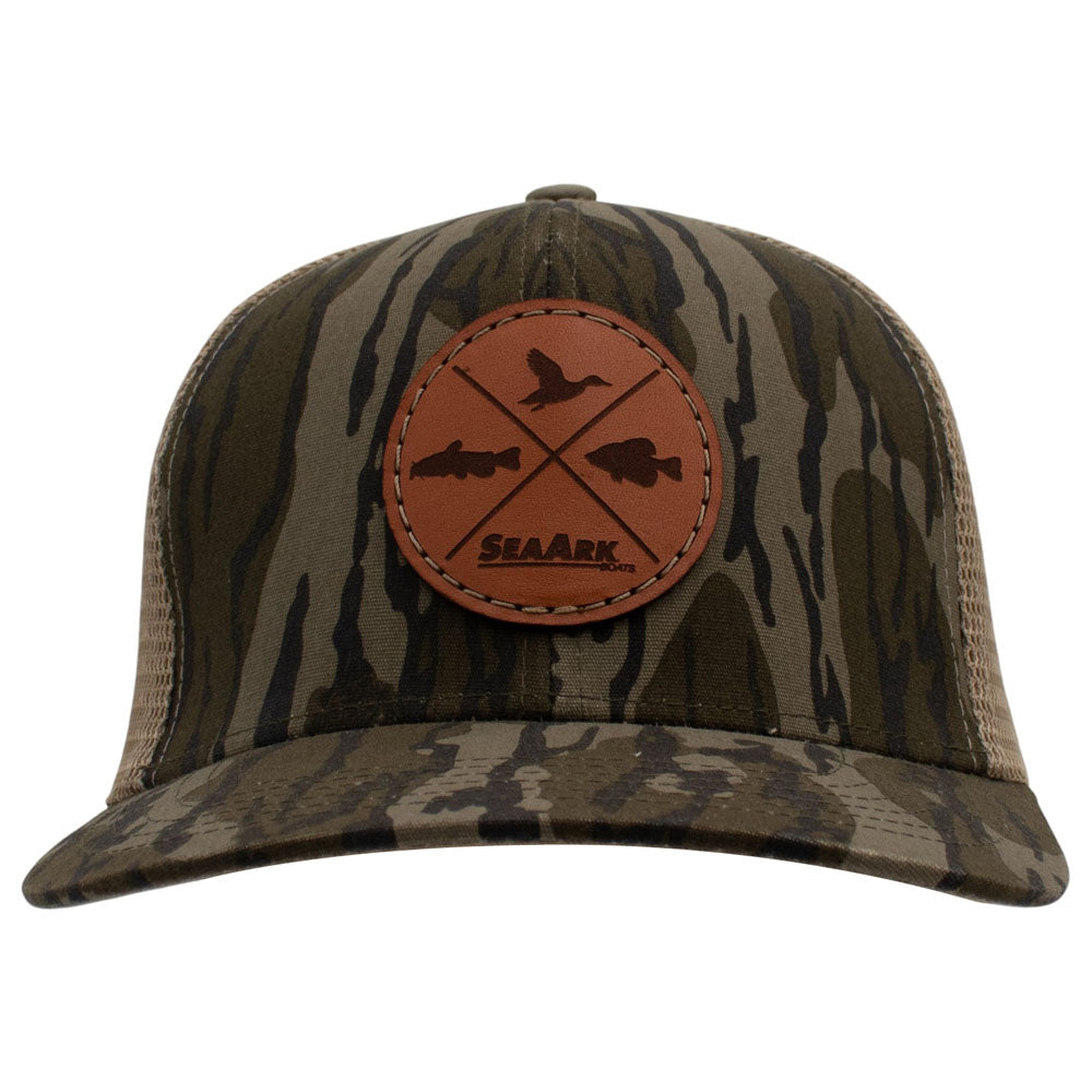 A green and beige camouflage trucker hat with a brown leather patch on the front featuring duck and fish silhouettes and the brand name SeaArk.