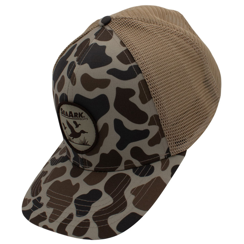 Side of a trucker-style cap with a tan mesh back and a front panel/brim featuring a brown, beige, and black organic camouflage pattern.