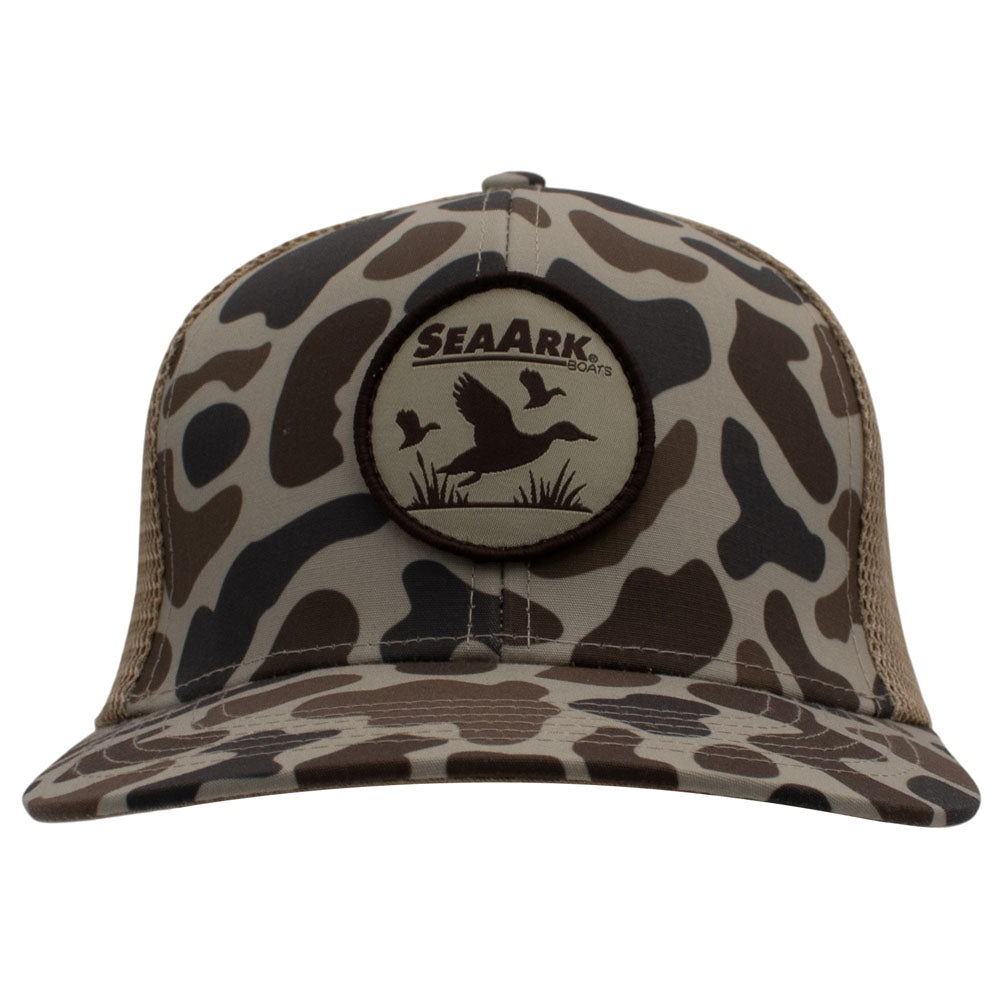 A SeaArk trucker hat with a brown, beige, and black camouflage pattern, featuring a circular SeaArk patch on the front and mesh back panels.