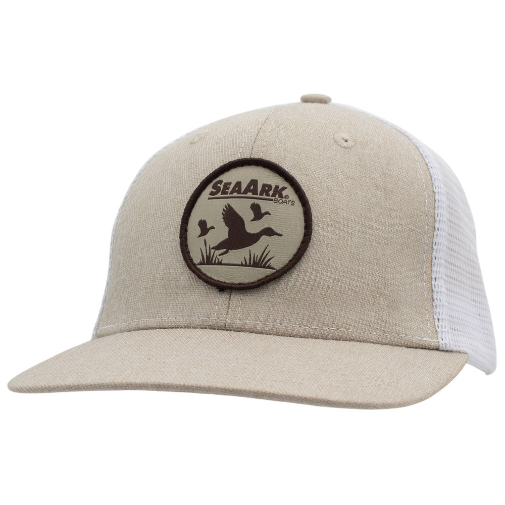 A beige trucker-style cap with white mesh back panels and a circular SeaArk patch on the front, shown against a plain white background.