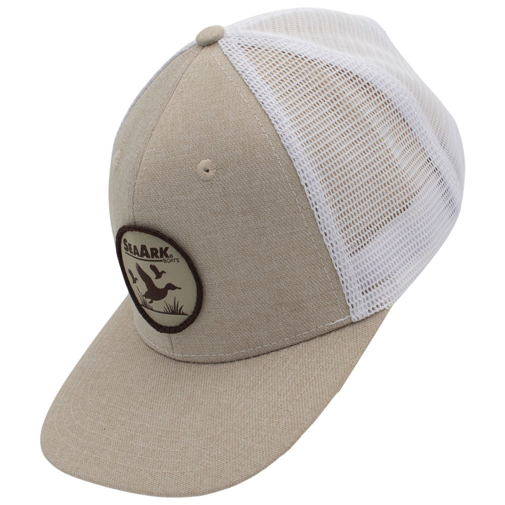 Side of a beige and white trucker-style cap with a curved brim, featuring a circular 'Sea-Ark' duck logo patch on the front panel.