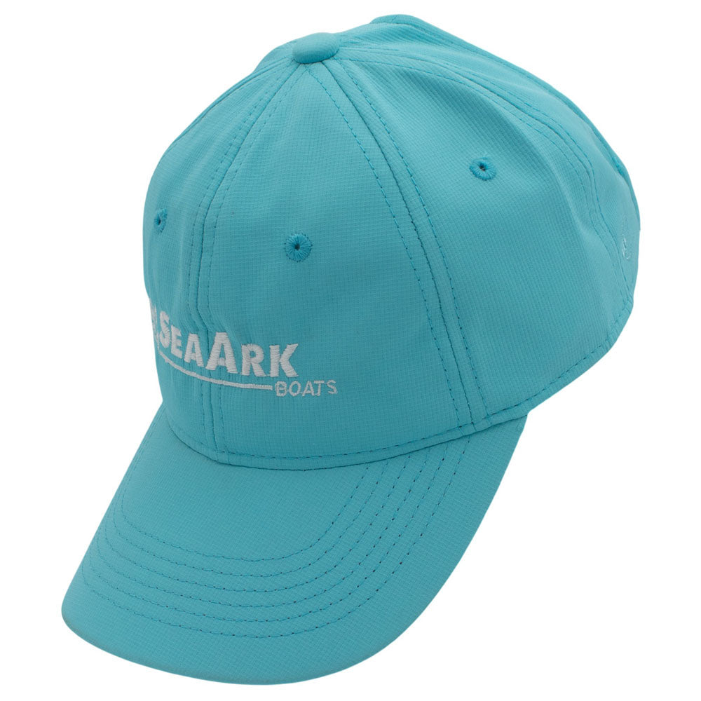 Side of a teal blue baseball cap with a white logo embroidered on the front.