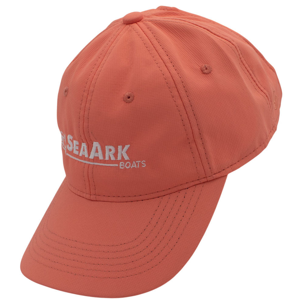 Side of a coral baseball cap with a white logo embroidered on the front.