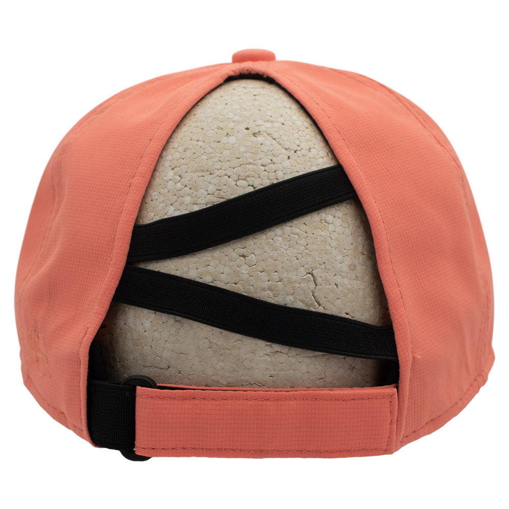 Back of a peach baseball cap with a unique crisscross strap designed for ponytails, displayed on a beige foam mannequin head against a white background.