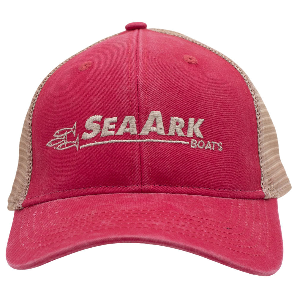 A faded trucker hat with 'SEAARK BOATS' embroidered on the front, featuring a reddish-pink fabric front panel and a tan mesh back.