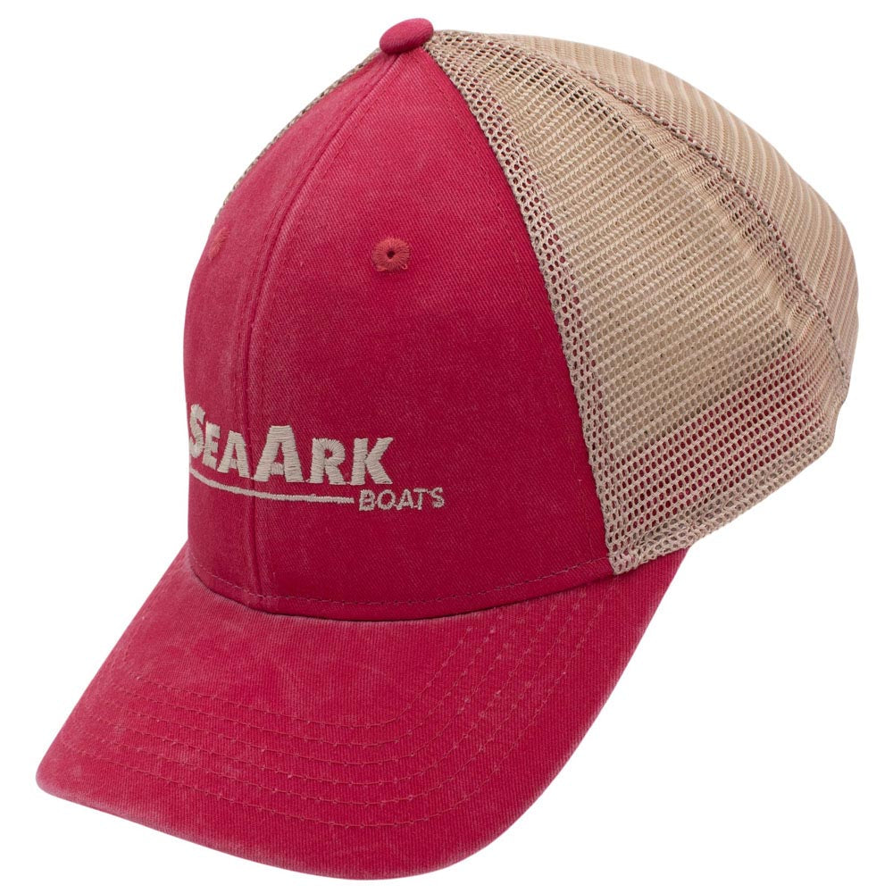 Side of a trucker-style baseball cap with a bright pink front panel and brim, tan mesh back panels, and a small embroidered logo on the front.