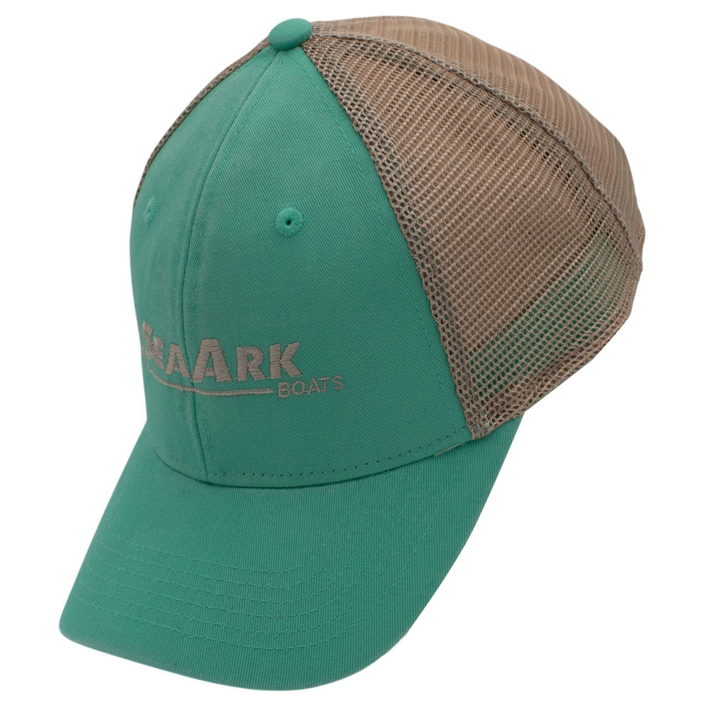 Side of a trucker-style baseball cap with a teal front panel and brim, tan mesh back panels, and a small embroidered logo on the front.