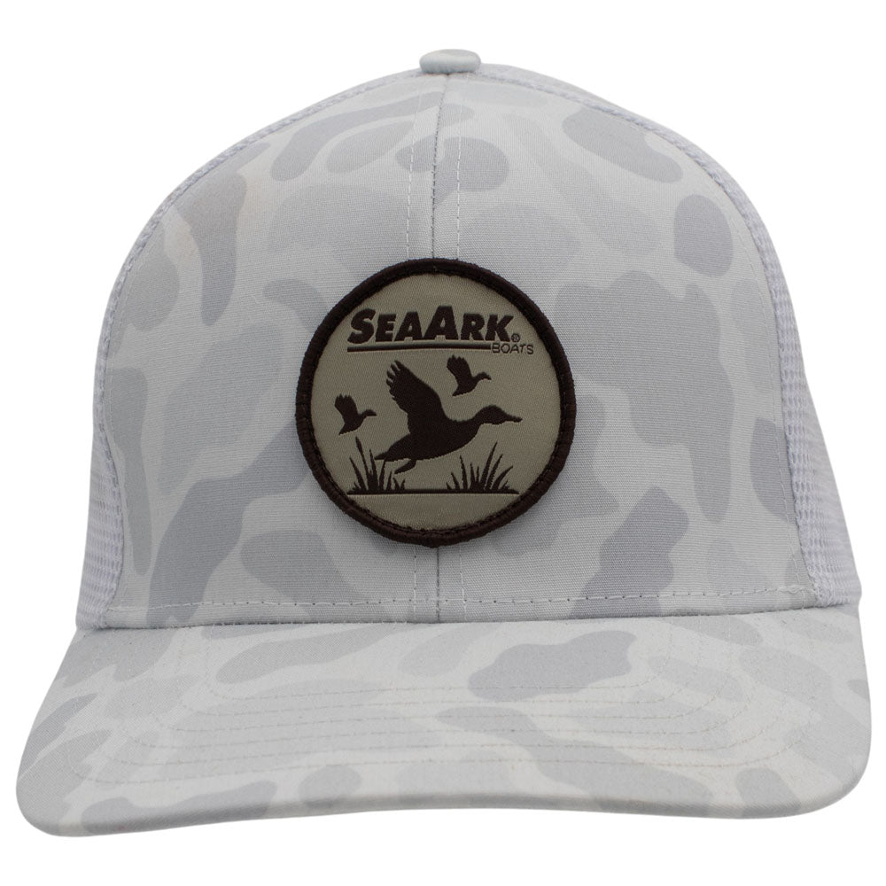 A SeaArk trucker hat with a white and grey camouflage pattern, featuring a circular SeaArk patch on the front and mesh back panels.